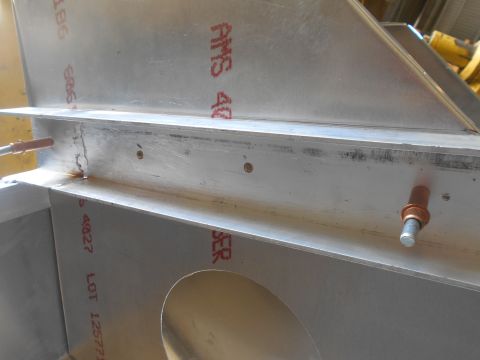 1992 Ford Bronco - The image shows a close-up of aluminum structural components with red stenciled markings and rivets. There are no vehicles or vehicle parts…