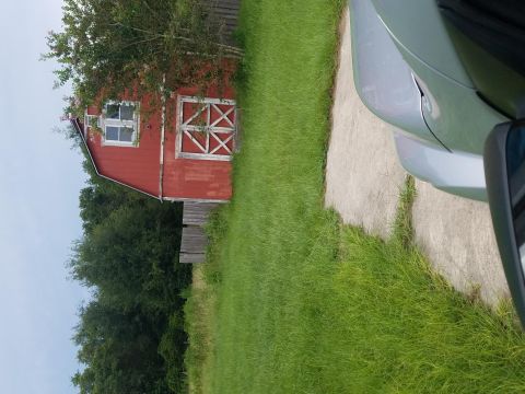 1994 Ford Bronco - Photograph of a red barn and yard scene, not a technical document.