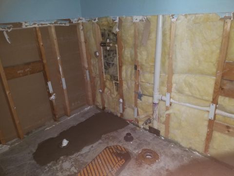 1994 Ford Bronco - Photograph of an opened wall with insulation and plumbing, not a technical document.