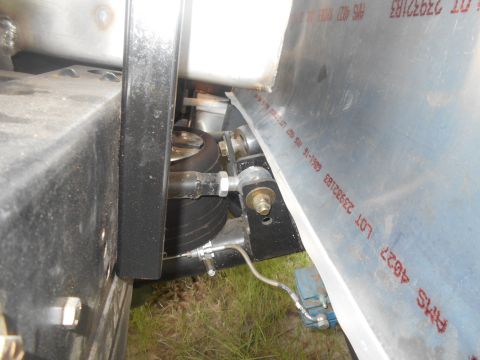 1992 Ford Bronco - A close-up view shows the air suspension system of a vehicle, featuring a black air bag and metal components. Red lettering is visible on a…