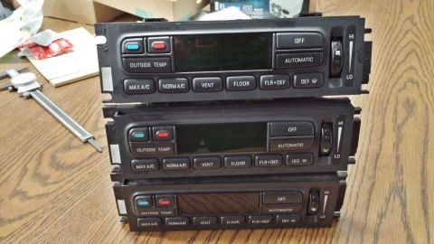 2005 Mercury Grand Marquis - A stack of three car stereo head units, possibly for a custom installation or parts.