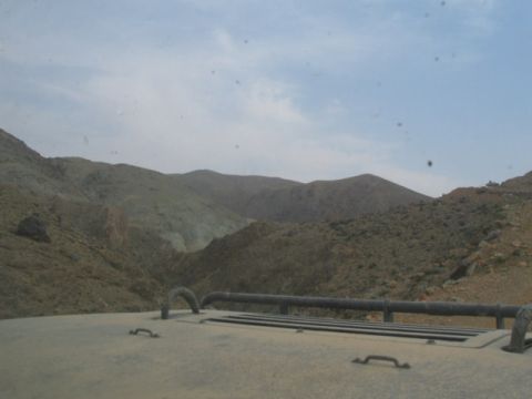 1981 Ford Bronco - Driving through a barren, mountainous terrain under a cloudy sky.