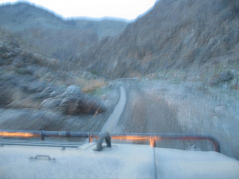 1981 Ford Bronco - Driving on a rough road through a desolate mountain landscape.