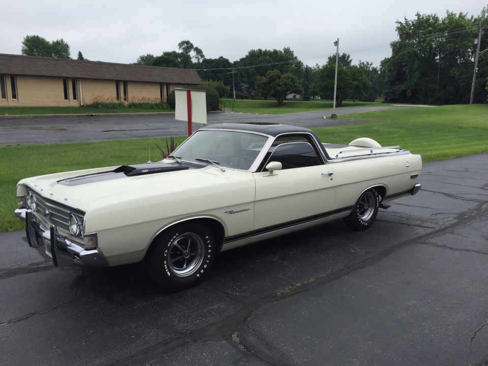 White Ford Ranchero with black roof and louvered hood parked in lot