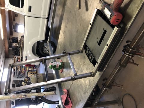 2018 Polaris RANGER - Metal frame being worked on in a garage with a white pickup truck in the background.