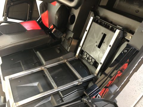 2018 Polaris RANGER - The interior of a utility vehicle shows black and red seats and a metal frame installed on the floor.