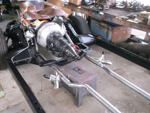 1967 Ford Galaxie - The chassis of a vehicle is shown with the engine and transmission assembly, along with exhaust system components.