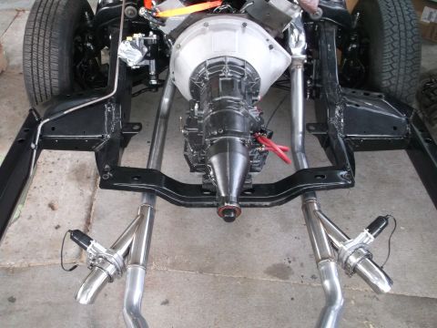 1967 Ford Galaxie - The chassis of a vehicle is shown with its powertrain and exhaust components installed.