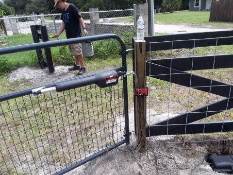 1994 Ford Bronco - Installing an automatic gate opener on a wire fence with a wooden post.