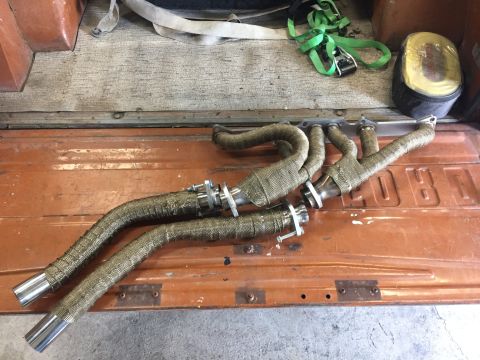 1969 Ford Bronco - Exhaust headers are shown in the bed of a truck, wrapped in heat-resistant tape.