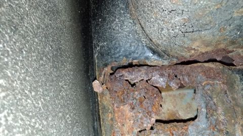 1996 Ford Bronco - Significant rust damage is visible on this vehicle's frame rail, indicating potential structural compromise.