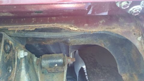 1996 Ford Bronco - Vehicle frame shows significant rust and corrosion, with a black wiring harness visible.