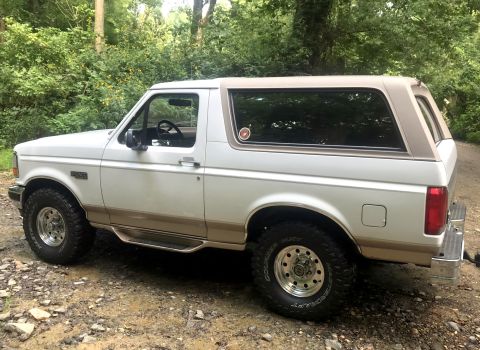 1996 Ford Bronco - This 1996 Ford Bronco is seen from a three-quarter front view, parked in a wooded area.