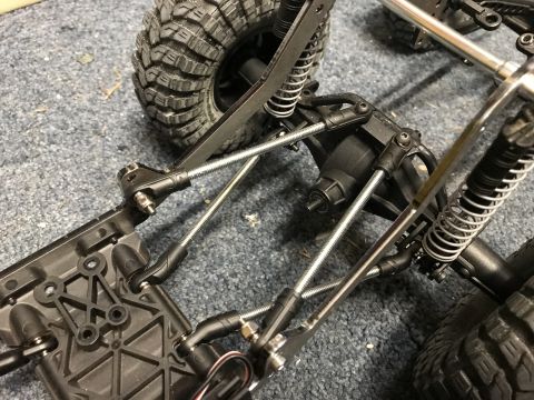 1989 Ford Bronco - Chassis components and suspension of a remote control vehicle are shown in this close-up view.