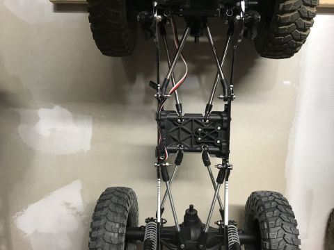 1989 Ford Bronco - The detailed undercarriage of a remote-controlled rock crawler, highlighting its suspension and mechanical components.