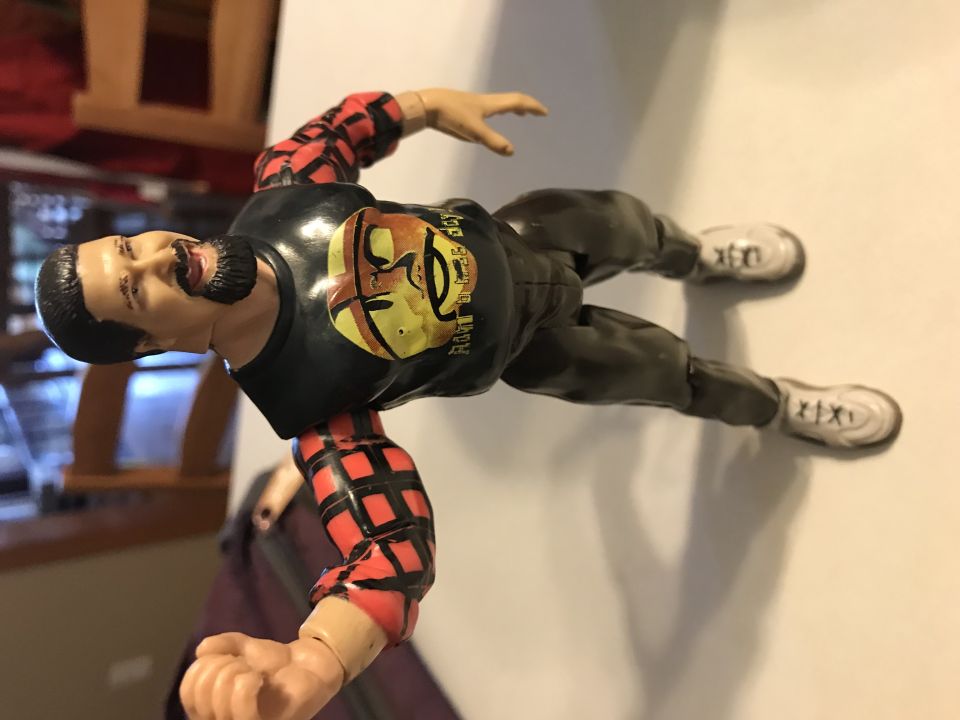 Action figure with black shirt and plaid sleeves