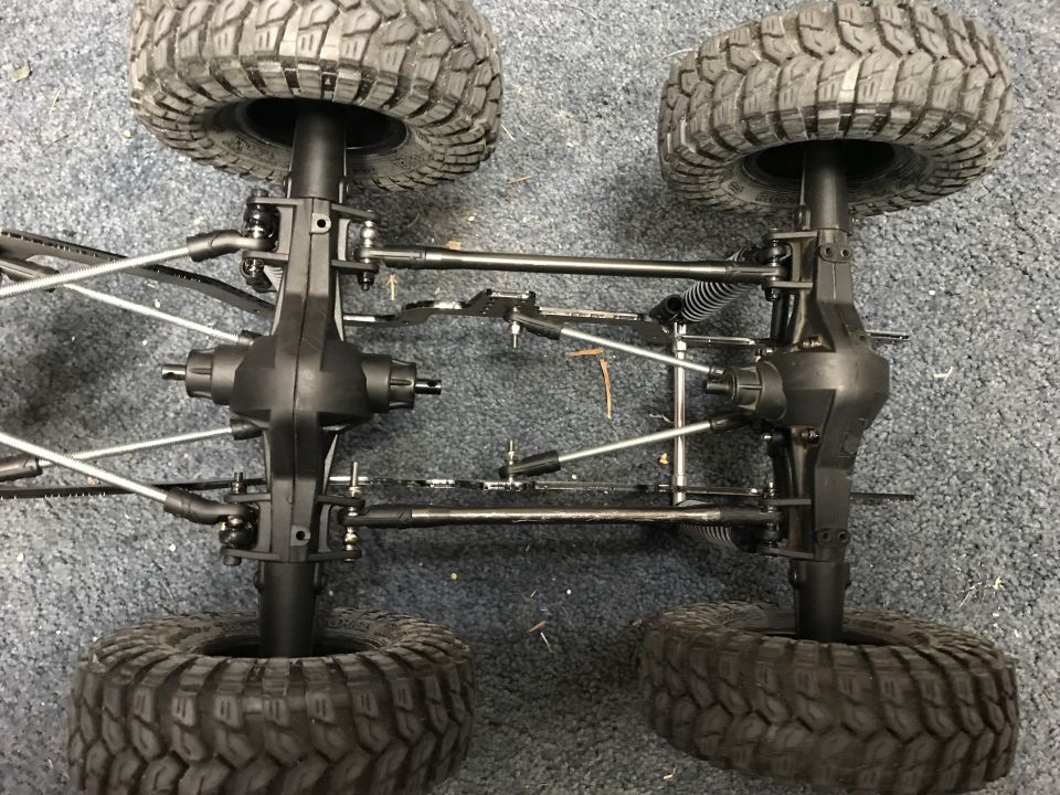 RC car chassis with large tires and suspension components visible