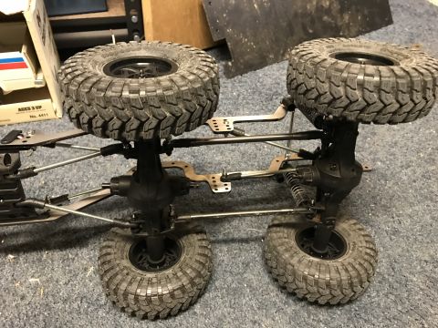 1989 Ford Bronco - The underside of an RC car chassis reveals its suspension and four-wheel-drive system.