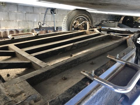 1970 Volkswagen Beetle - The underside of a trailer's metal frame is shown, with a tire and part of the hitch assembly visible.