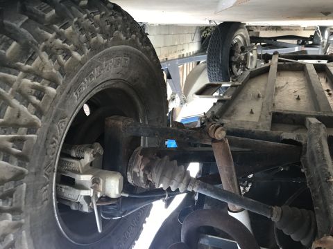 1970 Volkswagen Beetle - The underside of a vehicle is visible, with focus on the tire and suspension system.