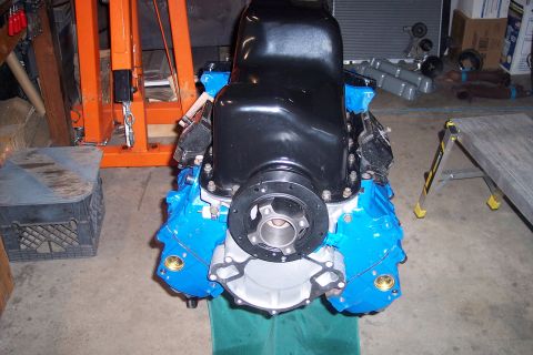 1995 Ford Bronco - Engine assembly with blue painted block and black oil pan, resting on a green cloth.