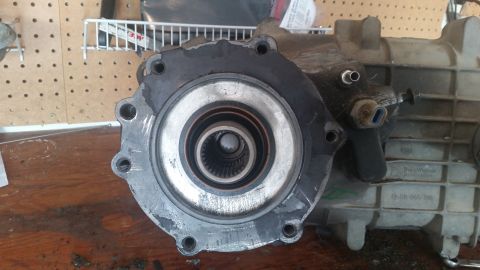 1985 Ford Bronco - Close-up of a vehicle transfer case part, showing the splined output shaft and mounting flange.