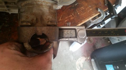 1985 Ford Bronco - A digital caliper measures a metal component, showing a reading of 1.666 inches.