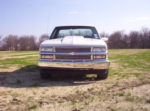 1988 Ford Bronco - This white Chevrolet truck is shown from the front, a prominent chrome bumper and grille.