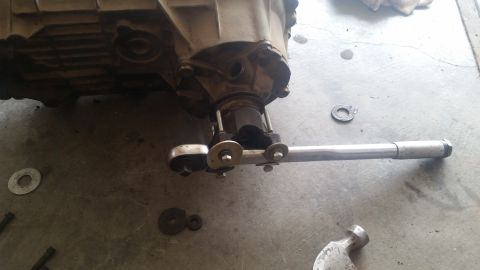 1985 Ford Bronco - Working on a transmission part with a torque wrench.