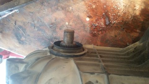 1985 Ford Bronco - Close-up of a splined shaft and seal on a vehicle component.