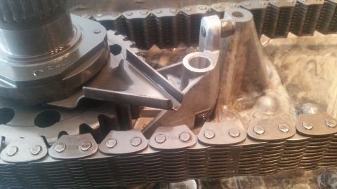 1985 Ford Bronco - Close-up view of a transfer case assembly, showing gears and a roller chain.