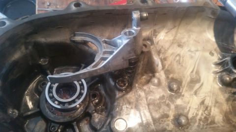 1985 Ford Bronco - Interior view of a transmission part with a bearing and fork assembly.
