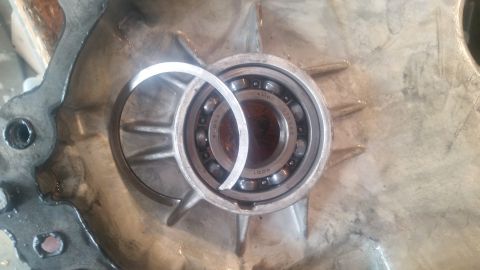 1985 Ford Bronco - A bearing is shown installed in a metal housing, with a split ring nearby.
