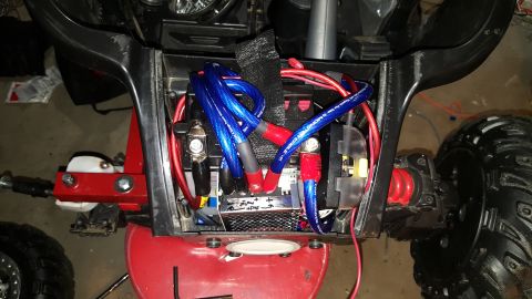 2007 Subaru Impreza - Close-up view of the wiring and battery compartment of an ATV, showing various electrical components and connections.
