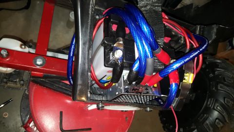 2007 Subaru Impreza - Detail of a battery with thick blue and red cables, likely for an audio system or other electrical upgrade.