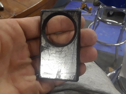 1994 Ford Bronco - A close-up shows a scratched metal component with a circular opening, held by a person's hand.