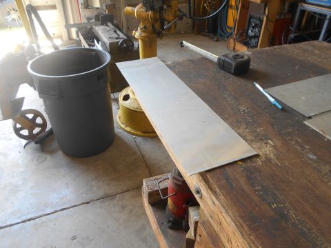 1992 Ford Bronco - A metal sheet rests on a workbench, with a trash can and various tools visible in the background.