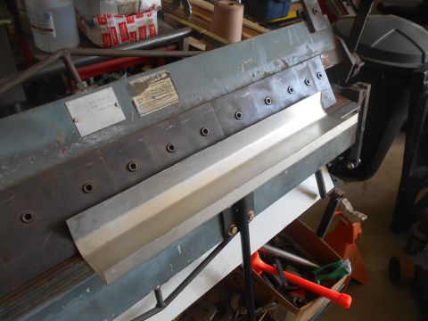 1992 Ford Bronco - A sheet metal brake is shown with a piece of aluminum being formed.