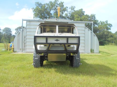 1992 Ford Bronco - This custom off-road vehicle features a heavy-duty front bumper and large tires, seen from the front.