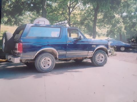 1994 Ford Bronco - 1994 Ford Bronco parked outdoors with a spare tire mounted on the back.