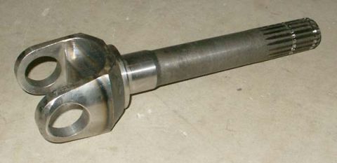 1995 Ford Bronco - A metal driveshaft yoke with two bolt holes and a splined end is shown against a concrete surface.