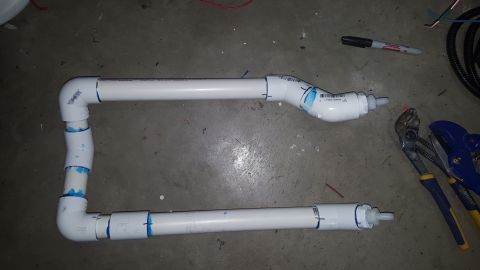 2007 Subaru Impreza - Custom PVC pipe assembly with fittings, tools nearby on a concrete floor.