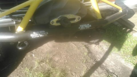 1978 Ford Bronco - A black aftermarket bumper with yellow roll cage supports is visible on a vehicle. Text on the bumper reads "Built With Blood Sweat & Curse…