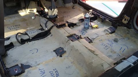2000 Pontiac Grand Prix - Interior of a 2000 Pontiac Grand Prix with the carpet removed, revealing the floor pan and various labels written in marker. A can of 3M ad…