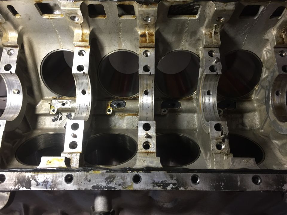 Close-up of engine block interior showing cylinder bores and crankshaft bearing journals.