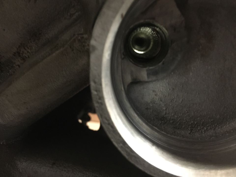 Close-up of threaded metal component interior with bolt