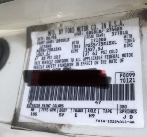 1995 Ford Bronco - Ford vehicle certification door data plate showing GVWR, axle weight ratings, tire sizes, and paint/axle/trans option codes.