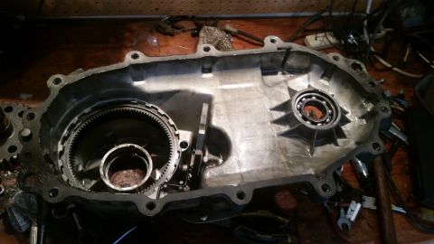 1985 Ford Bronco - This is a close-up, overhead view of the inside of a disassembled automatic transmission case. Visible components include gears, bearings,…