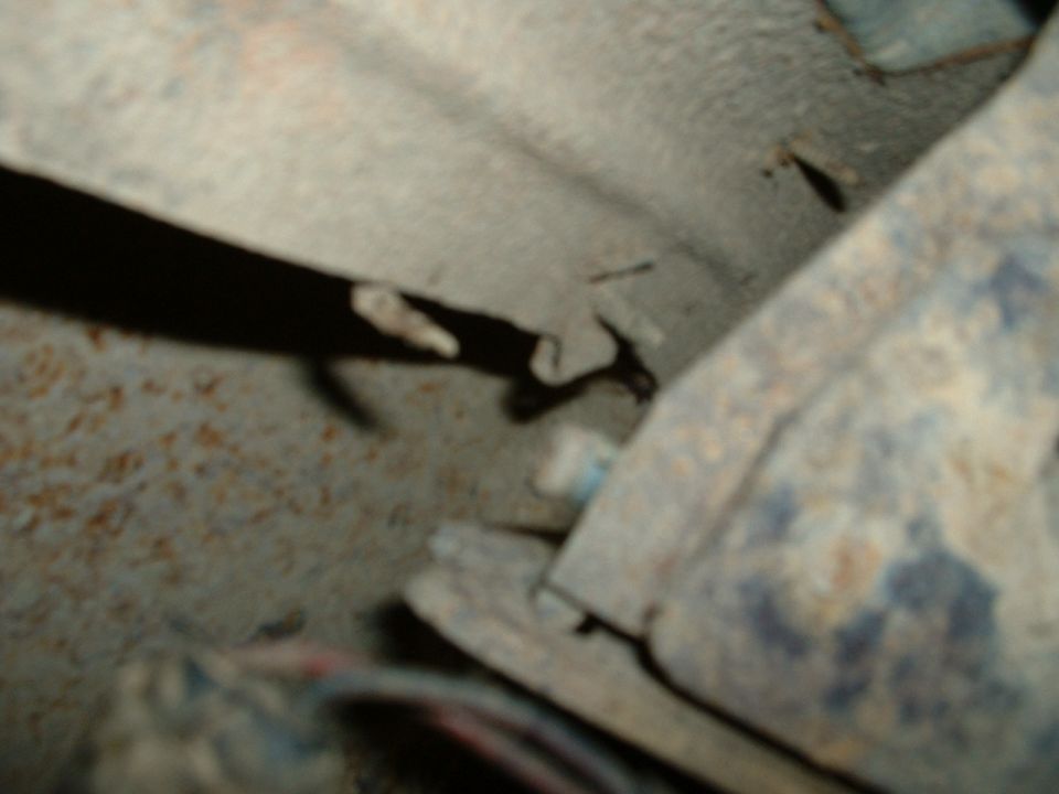 Close-up of rusted metal frame and drive shaft
