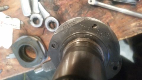 1985 Ford Bronco - A close-up view shows a metal part with stamped text that reads "DCAP TOP REAR". Several tools and other metal components are visible in th…